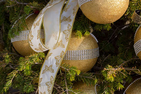 Fir branch with balls and festive lights on the Christmas background.