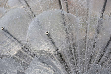 Splashes and drops, water movement abstract figure of a water fountain on blurred backgroundの写真素材