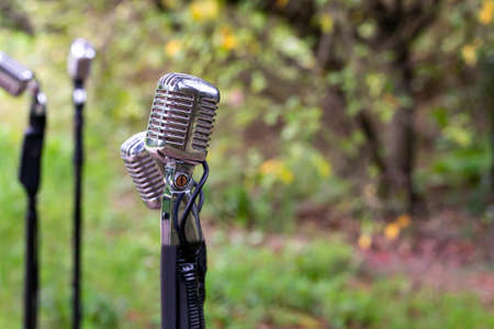 microphone standing for speaker on the outdoor natural setting for music, concert and environmental awareness talk with copy spaceの写真素材