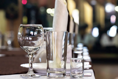 Served dinner table in a restaurant. Restaurant interior, lights from a Christmas tree in the backgroundの写真素材