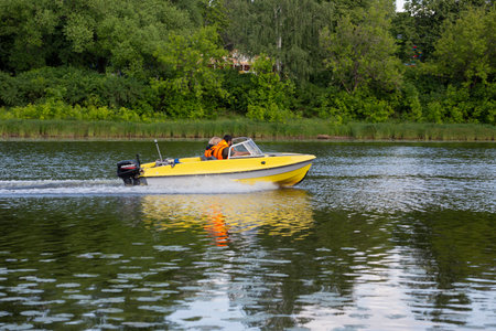 yellow motorboat on the Russia Yaroslavl River on August 10, 2023