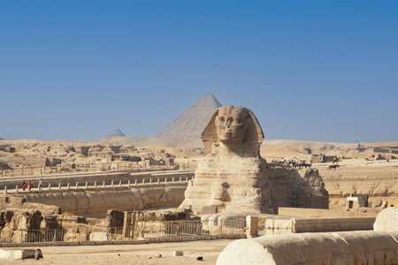 Beautiful profile of the Great Sphinx including pyramids of Menkaure and Khafre in the background on a clear sunny, blue sky day in Giza, Egyptの写真素材