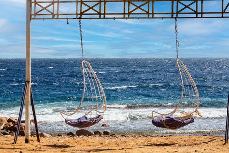 Swing on the beach with clear blue azure water - Dahab, Red Sea, Egyptの写真素材
