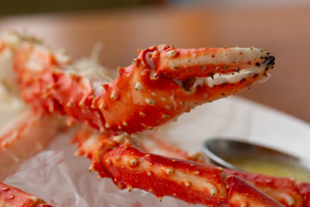 Claws of the crab Paralithodes camtschaticus on a white plate in a restaurant.の写真素材
