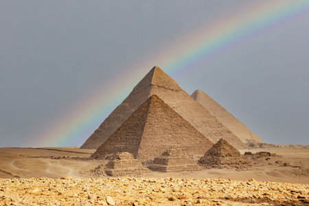 Egypt. Cairo - Giza. Rainbow over the pyramids. General view of pyramids from the Giza Plateau...