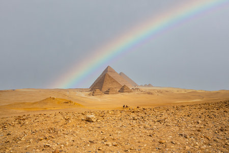 Egypt. Cairo - Giza. Rainbow over the pyramids. General view of pyramids from the Giza Plateau...