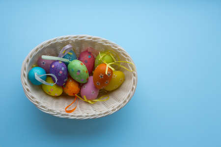 Basket with easter eggs with ribbonsの写真素材