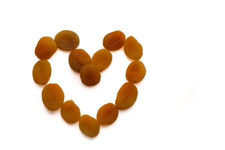 Apricots heart shape outline on white backgroundの写真素材