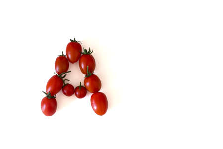 Letter A made out of small bright tomatoesの写真素材