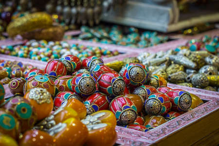 Glass bright jewellery beads in red tones, on at the Grand Bazaar market in Istanbul, Turkey. Artistic background.の写真素材