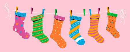 Baby socks with textures and patterns on a rope with colored clothespins. Vector illustration.のイラスト素材