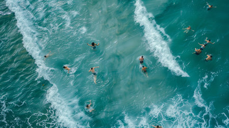 Aerial View of Swimmers Enjoying Turquoise Ocean Wavesの素材
