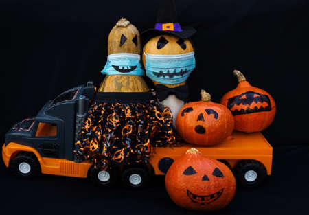 Celebrating Halloween in new reality of  pandemic. cheerful family of orange pumpkins getting ready...