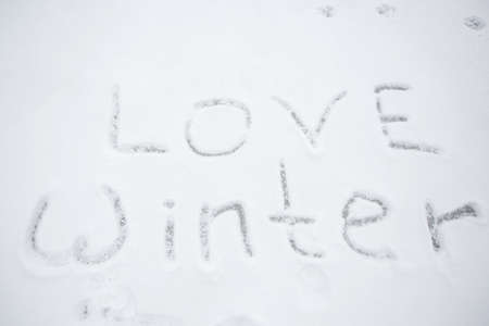 snow with the inscription love winter. Christmas Eve walks, fun, winter holidaysの写真素材