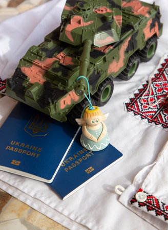 Conceptual layout from Ukrainian passport, national clothes, military tank, souvenir angel. war in Ukraine, Russian invasion. Support Ukrainian refugees.の写真素材