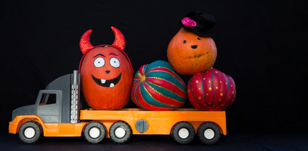 large children's toy car truck loaded with beautiful decorative pumpkins. Preparation delivery of...