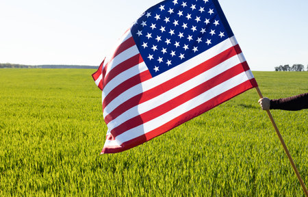 American flag on green grass background. independent day concept. patriotic holiday USA, Pride to be an American. freedom, national consciousness. Travel around the countryの写真素材