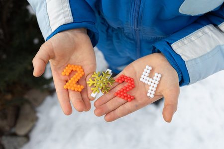 Christmas, New Year, festive mood. multi-colored numbers 2024 in the hands of a child. Time to make...