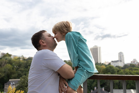 wo people - father and son touch each other with their noses. tenderness, paternal care, pleasant time with the child. walks together. moment of intimacyの写真素材