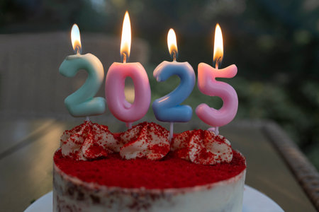 Burning Candles number 2025 on the cake. Happy New Year. festive pictures on a New Year's theme. Time to make wishesの写真素材