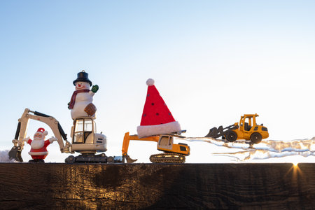 funny photo of toy construction equipment models, excavators, souvenir snowman, Santa Claus, large...