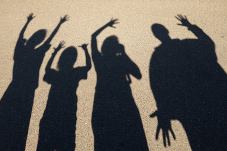 group of friends or a family of four having fun playing with shadows and light.