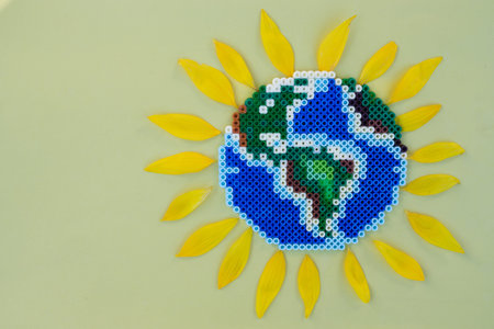 Preparing for Earth Day. Top view of a mosaic product resembling the planet Earth, sunflower petals...