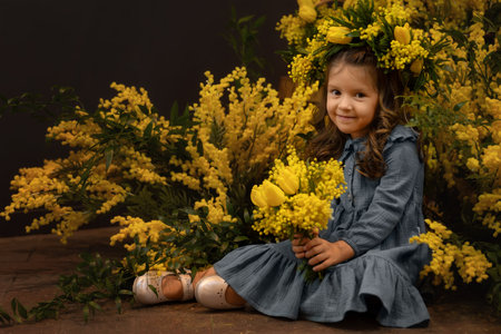 Beautiful girl with a bouquet of mimosa flowers. close-up portraitの写真素材