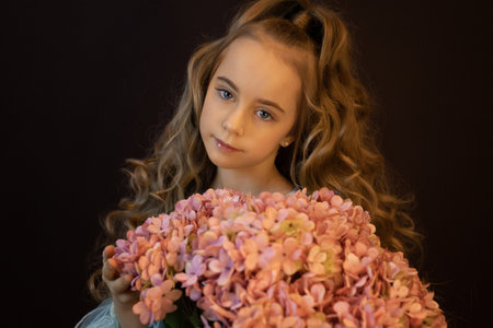 beautiful girl with a big bouquet of hydrangeasの写真素材
