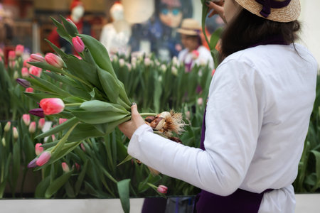A seller in a flower shop creates a bouquet.の写真素材
