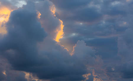 Gray clouds before a thunderstorm, neutral background, sky with clouds and sunの写真素材