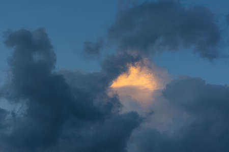 Gray clouds before a thunderstorm, neutral background, sky with clouds and sun