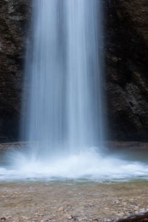 Blurred water of the waterfall close up. Beautiful abstract drawing of water on a long exposure. The...