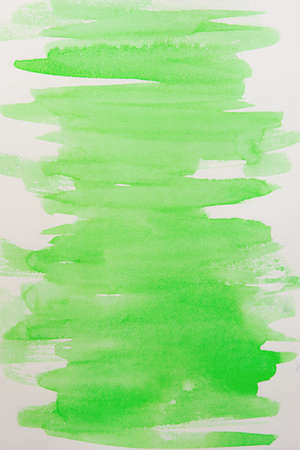 Watercolor background fill in a soft green color. Beautiful movement in the brush on watercolor paper. Handmade work. Unique performance. Creative watercolor backgroundの写真素材