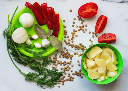 Ingredients for lentil soup. Red bell peppers, lentils, onions,garlic, spices and tomatoes on the...