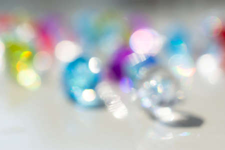 Multi-colored blurred abstract background with bokeh. Light Sunny background. Layout for the new year. Glittering multicolored balls in unfocused form.の写真素材