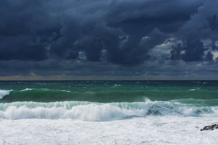 A violent storm in the sea. Beautiful blue storm clouds. A cloudy, menacing landscape. A terrible...