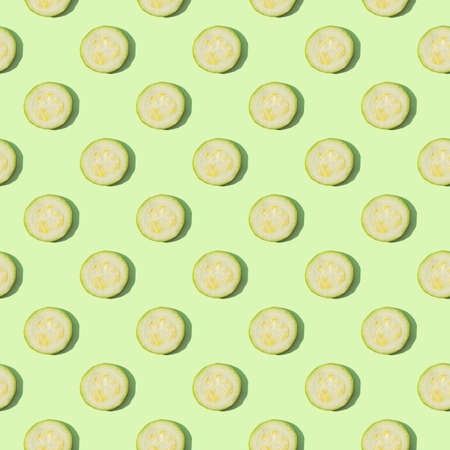 Zucchini isolated on a green background. Seamless pattern of zucchini on a mint background. Flat...