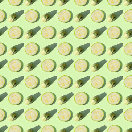 Zucchini isolated on a green background. Seamless pattern of zucchini on a mint background. Flat...