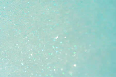 Abstract mint background with small sequins. The trending color of 2021. Bright greenish-turquoise...