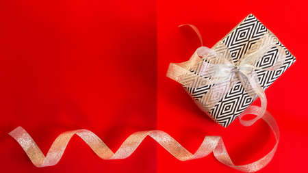 New year's gift on a red background. Merry Christmas and happy New year. Colorful bright design....