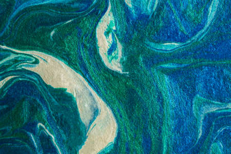 Turquoise blue abstract background in the technique of fluid art. liquid art pattern. Original art. Simulation of the depth of the ocean and the sea surface. Modern design. Drawing with acrylic paintsの写真素材