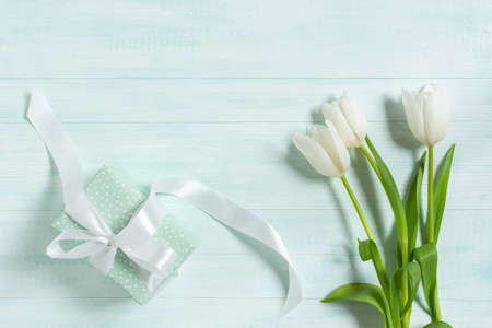 March 8, Women's Day, Mother's Day greeting card with white tulips on a wooden background. Top view,...