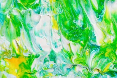 Abstract yellow-green acrylic background. Hand-drawn painting with liquid acrylic. Natural...