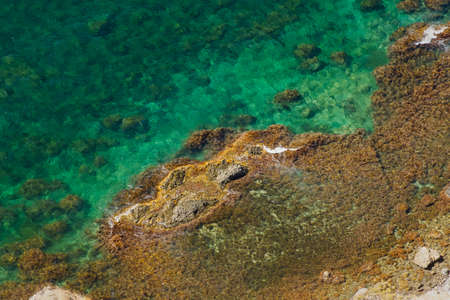 The texture is ocean stones. Turquoise sea water aerial view. Natural tropical background for summer...