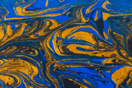 Abstract space blue gold black background. Acrylic painting fluid art. Golden waves of the ocean. Conceptual art drawing. Fashionable background for posters, postcards, invitations. Contemporary artの写真素材