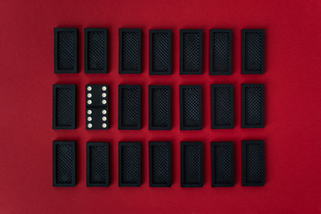 Domino minimalistic red and black background. Conceptual modern art design. Six by six is an open card. Gambling, mysterious flat background top view. Rectangular rows of dominoes. Abstract minimalismの写真素材