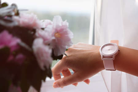 Watch wrist flowers. Pastel greeting card for Valentine's Day, Women's Day, Mother's Day. The concept of romance, tenderness, love, manifestation of feelings. Gift bouquet of pink beautiful flowersの写真素材