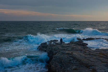 Blurred movement of the man of the sea. Abstract background of a man jumping into the water. Blue...