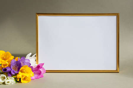 mother's day. Greeting card with beautiful freesia flowers on a gray background a white table. Bright spring design vertical floral mockup, creative composition in a white vase. Women's Day, March 8の写真素材